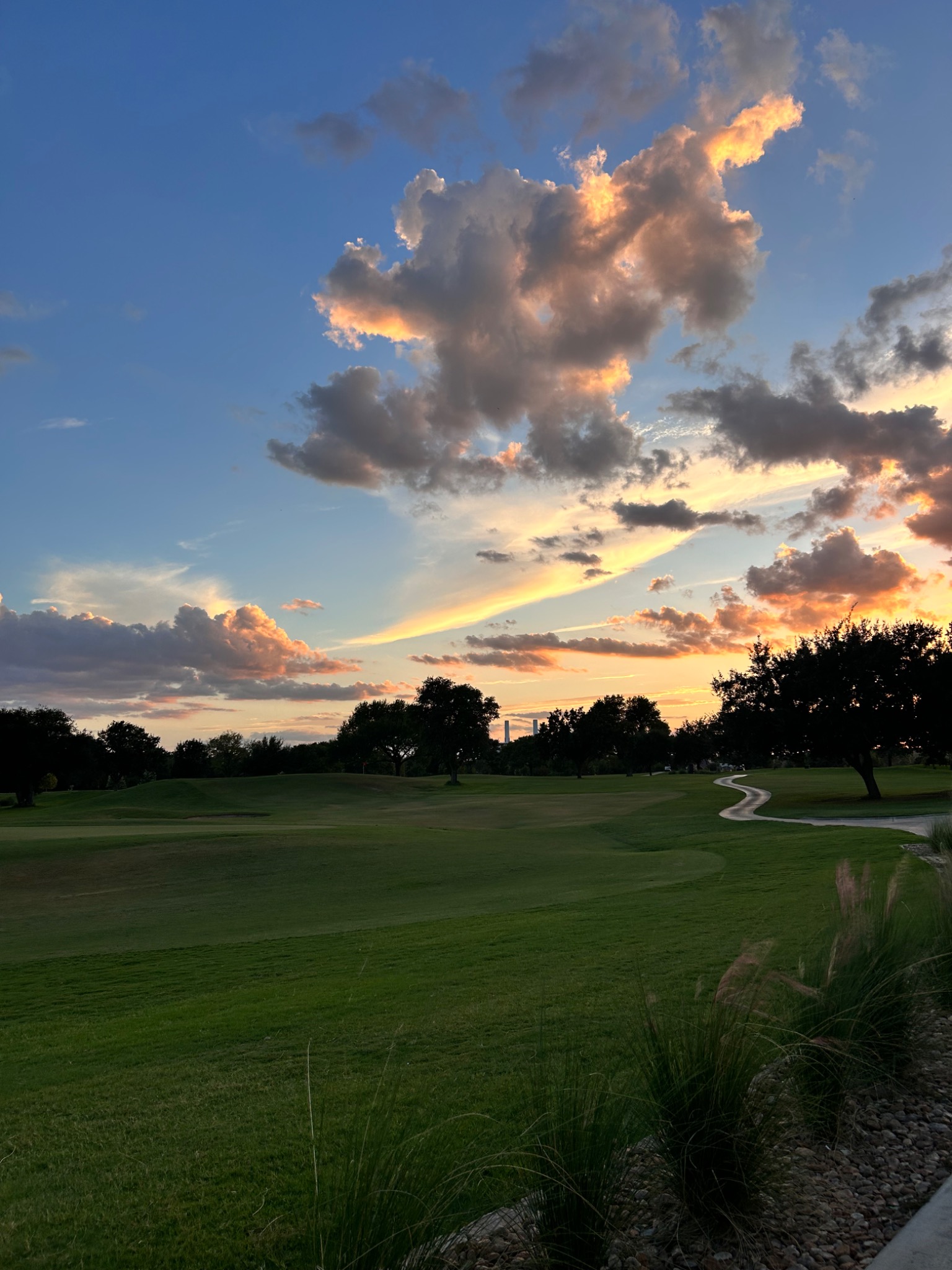 Golf course beneath a dramatic Texas sunset